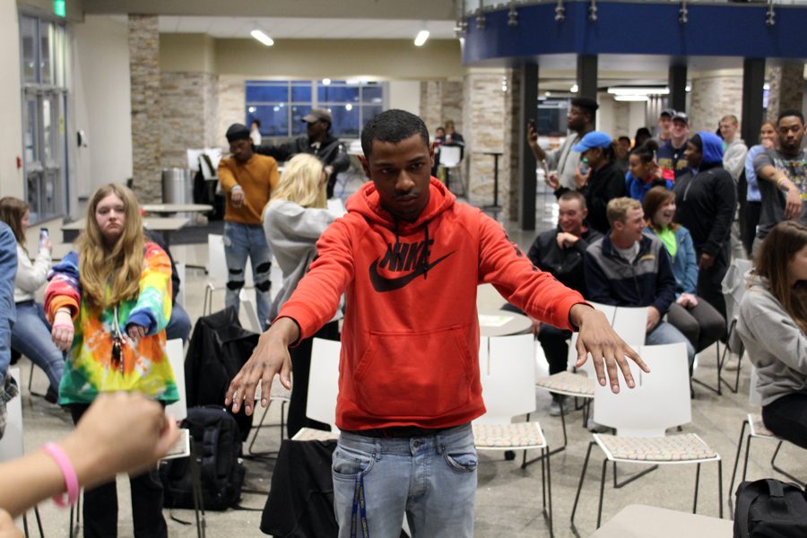 A student reacts to being hypnotized during a presentation by hypnotist Christ Jones.