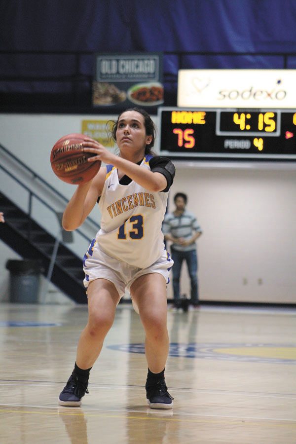Cristina De La Cruz, #13, focusing on shooting a free throw and trying to earn more points for the team.
