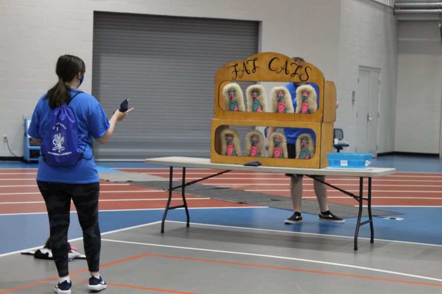 A student tries one of the carnival games during Blazerpalooza.