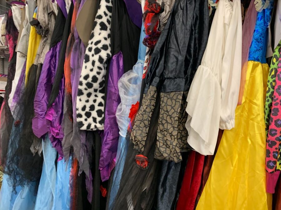Colorful Halloween costumes hang in a local store.