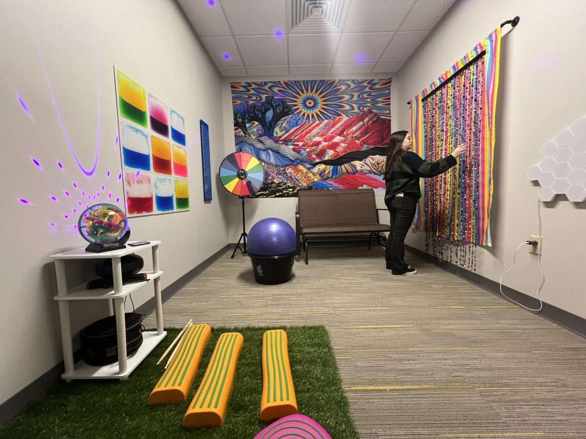 VU student and Trailblazer Emma Culver plays with hanging beads inside the stimulating sensory room at the Shake Learning Resource Center. Both it and a contrasting calming room are both available for students to use for an hour at a time.