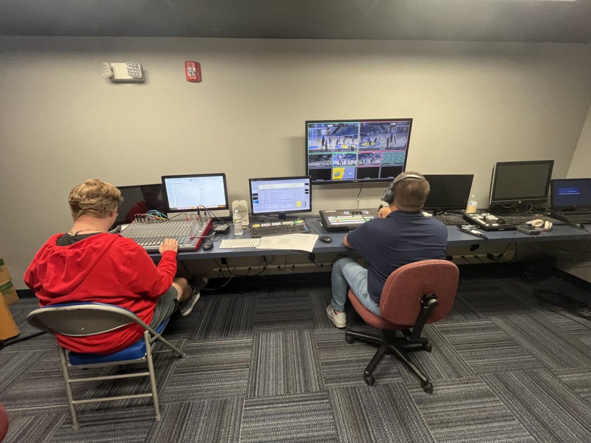 VU Broadcasting student Sam Harshbarger and BlazerVision coordinator Stewart Brooking work on audio and graphics in the BlazerVision studio.
