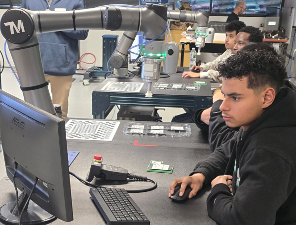 High school students interact with collaborate robots at a recent Innovation Cobot Workshop at Telamon Robotics in Carmel.