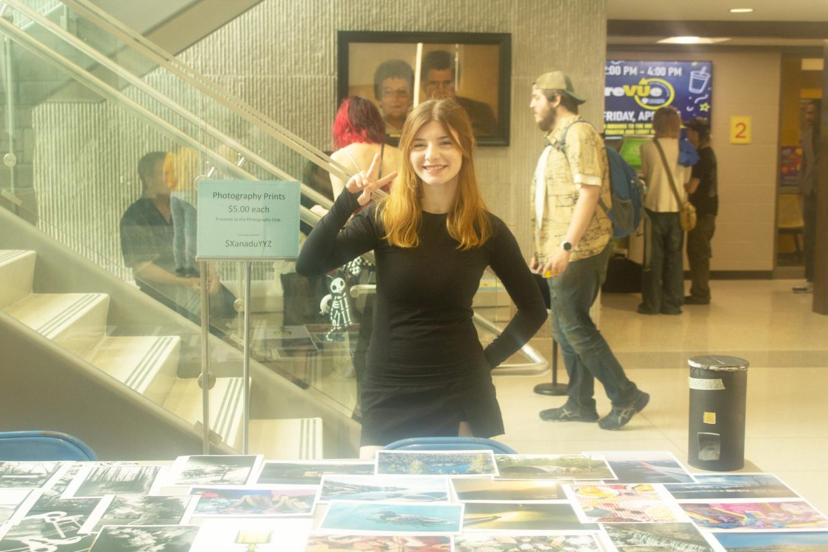 Vincennes University general studies major Haley Hines sells photos for the Photo Club at the ReVUe Art and Music Festival, held April 25 in the Shircliff Humanities Building. 